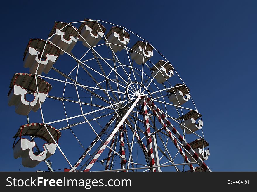 Big ferris wheel on the blue sky.