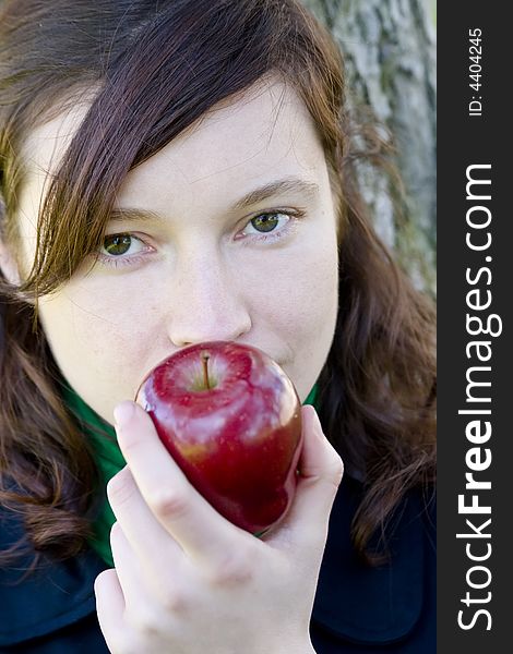 Green eyed young girl with apple. Green eyed young girl with apple