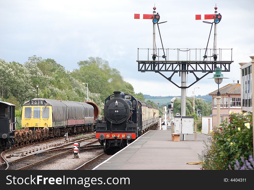 Steam Train Approaching Station passing lowered signal,guard passing tally to signal man. Steam Train Approaching Station passing lowered signal,guard passing tally to signal man