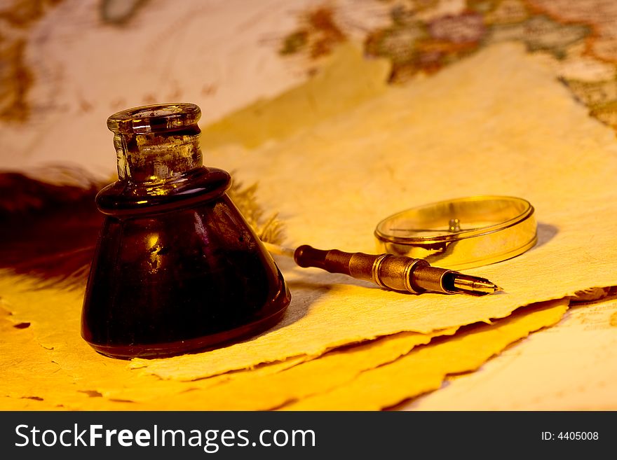 Quill, inkwell, compass, and paper with an antique look. Quill, inkwell, compass, and paper with an antique look
