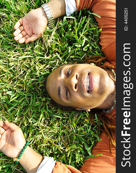 Man lying on the grass and smiling. Man lying on the grass and smiling