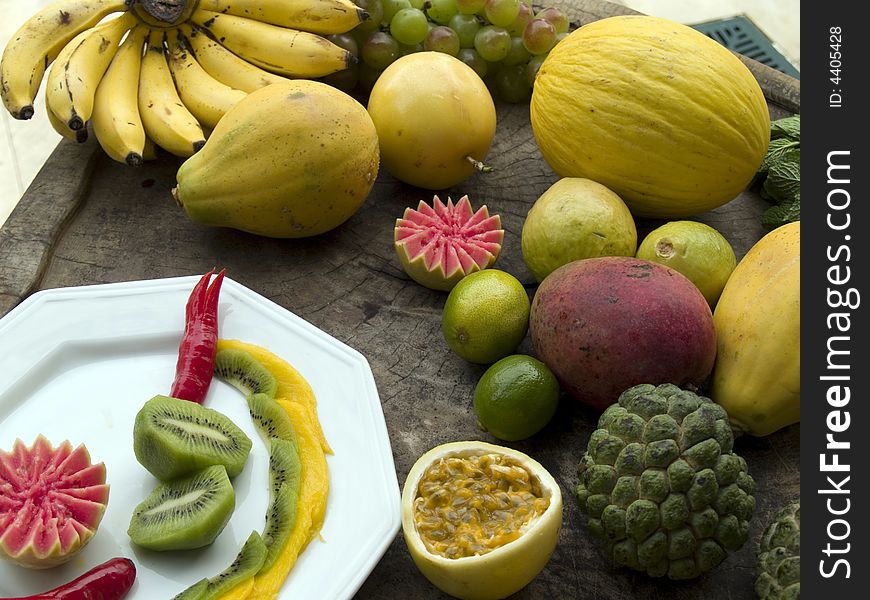 Exotic fruits on plate and wooden block