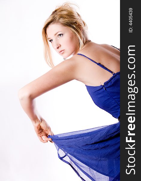 Young girl in a dress in the studio on a white background. Young girl in a dress in the studio on a white background