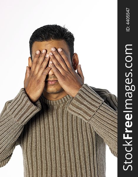 Young indian man with hands over his face. Young indian man with hands over his face