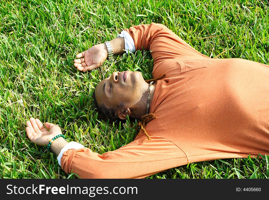 Man lying on the grass sleeping. Man lying on the grass sleeping