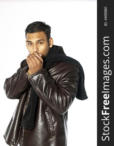 Young indian man with hands over his mouth in leather jacket and scarf. Young indian man with hands over his mouth in leather jacket and scarf