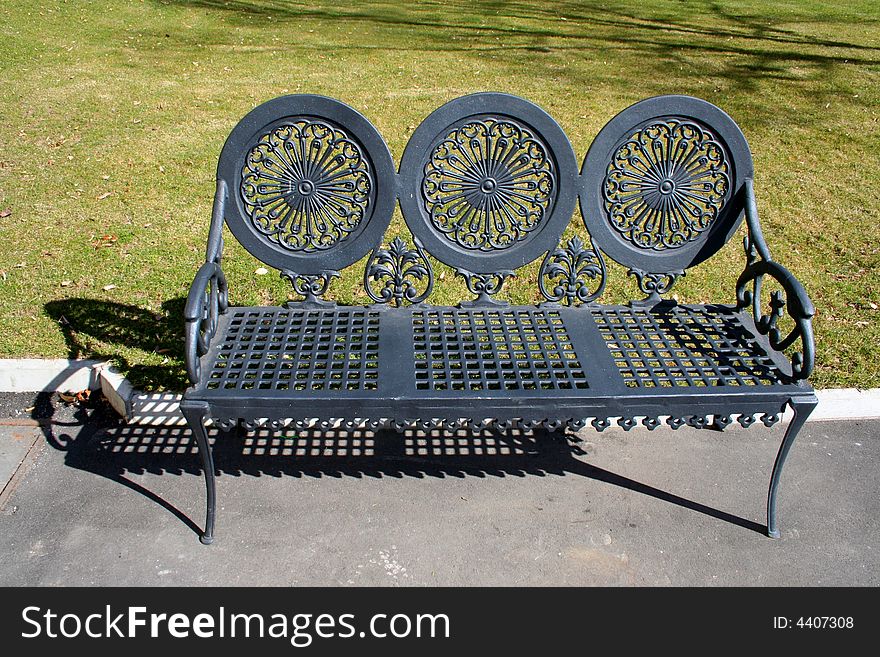 Decorated bench of cast iron in the park.