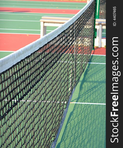 Close up detail of a tennis net stretchiing across a tennis court. Close up detail of a tennis net stretchiing across a tennis court