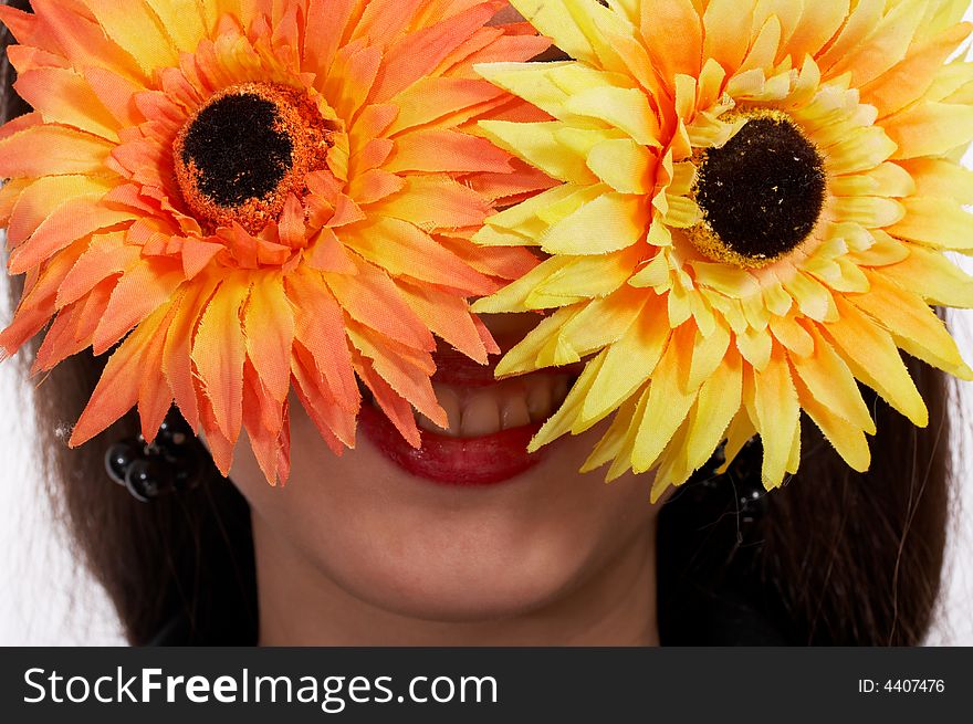 Young woman with flowers covering her face