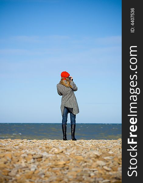 Girl Standing On The Beach