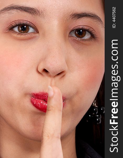 Young girl with finger over her lips