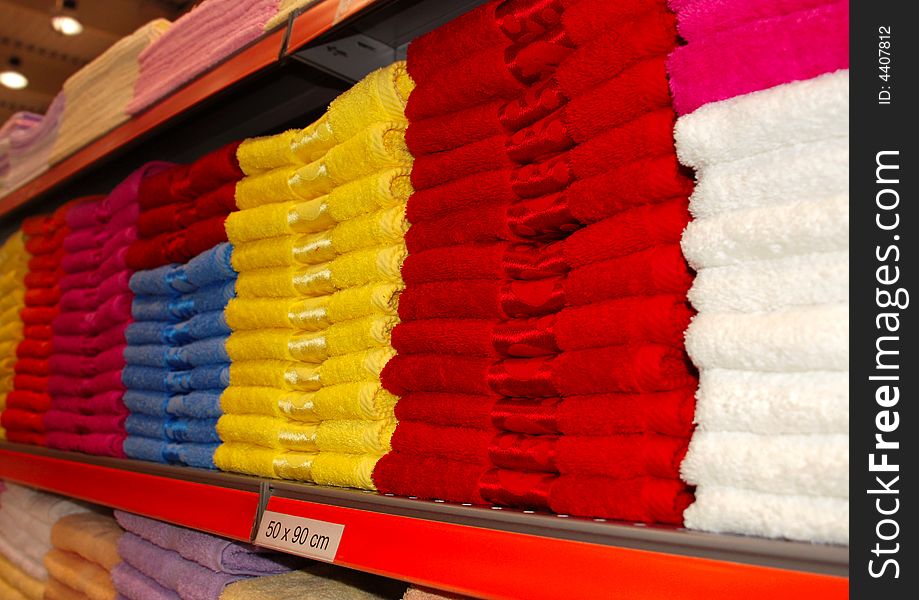 Colorful towels in row on shelf