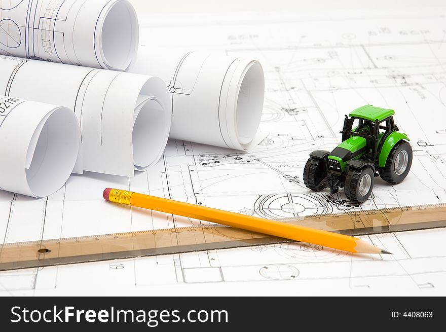 Constructor drawings and scale model at engineer`s workplace