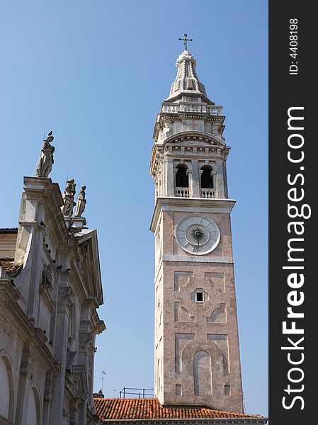 Bell tower and church facade clear sky in Venice, Italy.