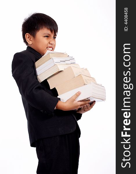 Worried young boy carrying a stack of books