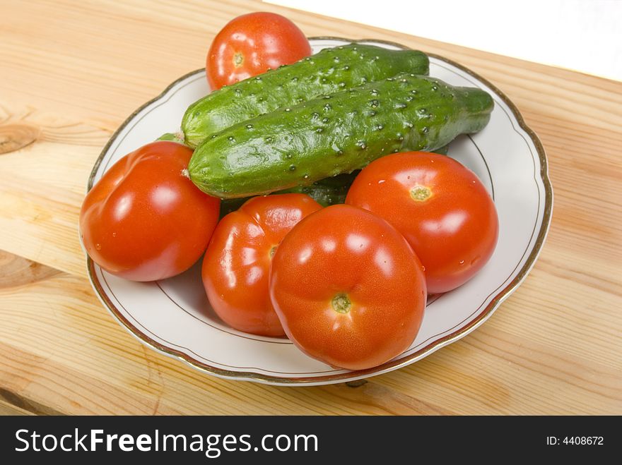 Still Life with tomatoes and cucumbers on blow. Camera Pentax k10d.