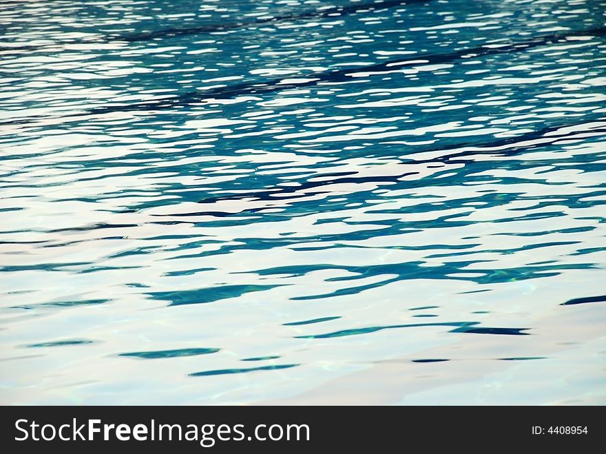 An image of the surface of the water of a swimming pool. An image of the surface of the water of a swimming pool