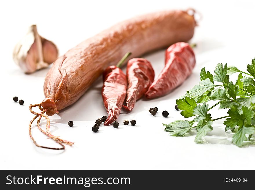 Appetizing smoked sausage with pepper and parsley