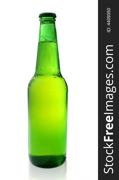 Cold chilled beer in green bottle on white background with relfection