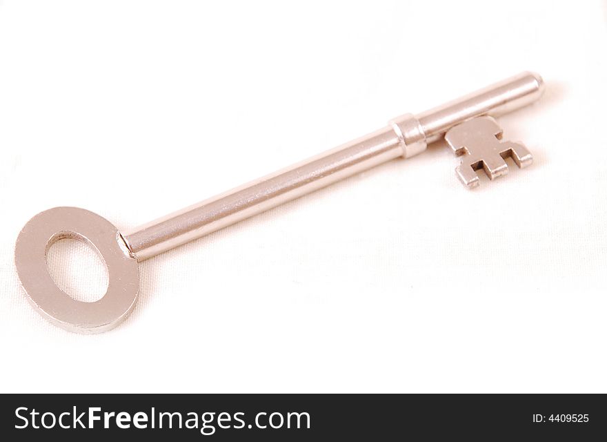 A single silver key on white cut out. A single silver key on white cut out.