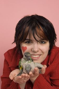 Beautiful Woman Holding Baby Parrot Stock Photo