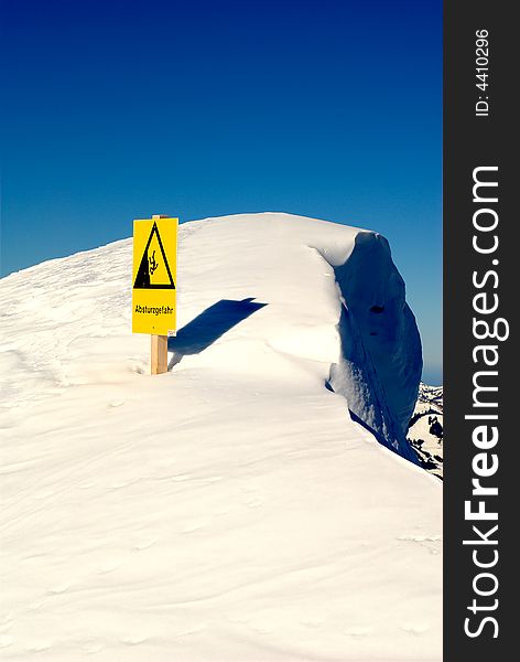 Warning sign about danger of falling hazard seen at the summit of the Nebelhorn (Foghorn) near Oberstdorf, Allgaeu Alps, South-Germany