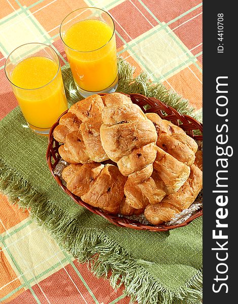 Sunny morning breakfast with croissant and orange juice