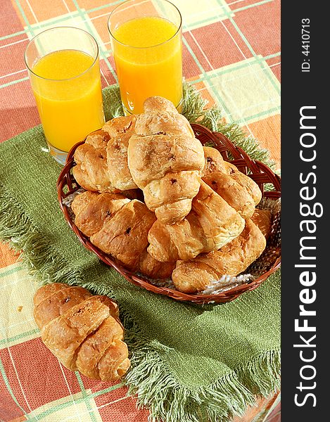 Sunny morning breakfast with croissant and orange juice