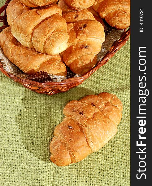 Fresh croissants in basket close-up view