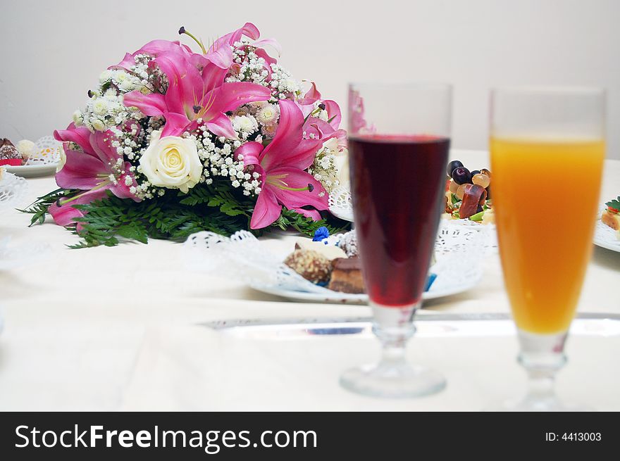 Two glasses, flowers and candy on the table