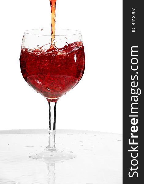 Wine glass with a stream red wine. Wine glass with a stream red wine