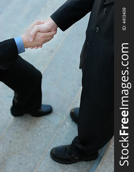 Businessman Gives a Handshake while he's stepping forward. Businessman Gives a Handshake while he's stepping forward