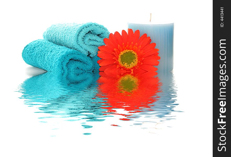 spa like image with a candle, flower and wash cloths with a rippled reflection. spa like image with a candle, flower and wash cloths with a rippled reflection.