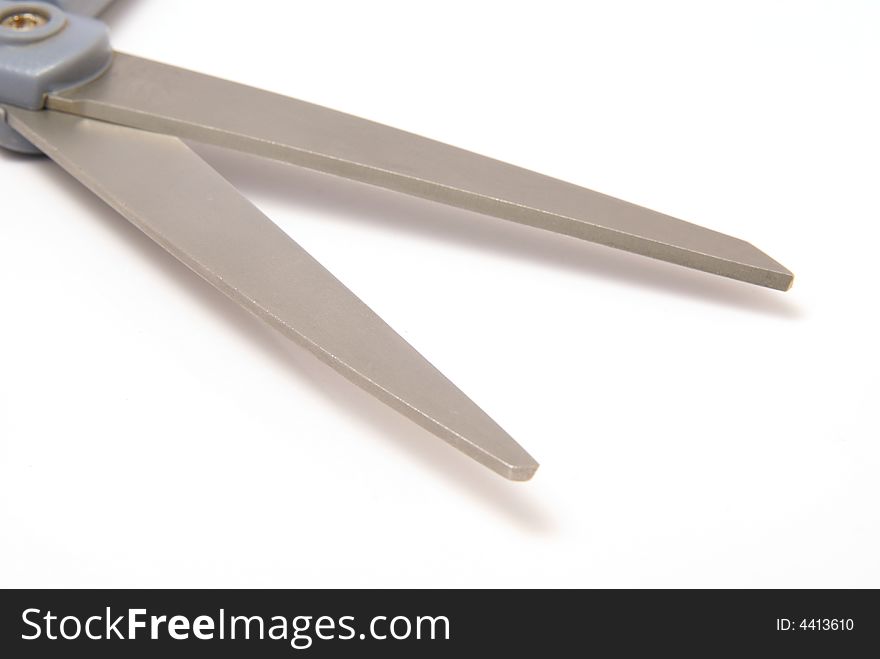 Metal scissor blades open on white