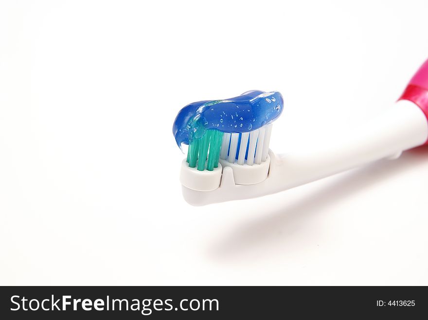 Toothbrush with clear gel toothpaste on bristles over white background. Toothbrush with clear gel toothpaste on bristles over white background