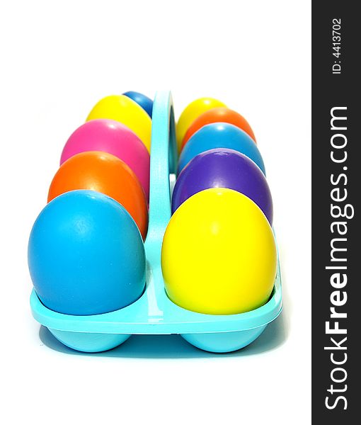 Easter holiday. Color eggs in a tray on white  background.