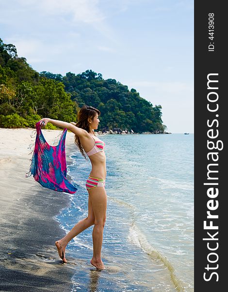 Young woman having fun at the beach