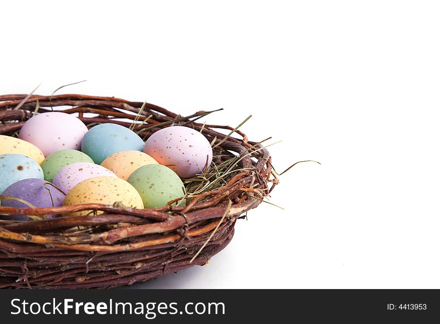 A close-up of easter eggs in a bird's nest. Perfect for easter concept. Isolated on white. A close-up of easter eggs in a bird's nest. Perfect for easter concept. Isolated on white.