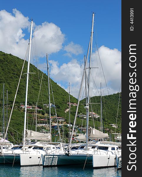 White as clouds catamarans anchored in one of many harbours on Tortola island, British Virgin Island. White as clouds catamarans anchored in one of many harbours on Tortola island, British Virgin Island.