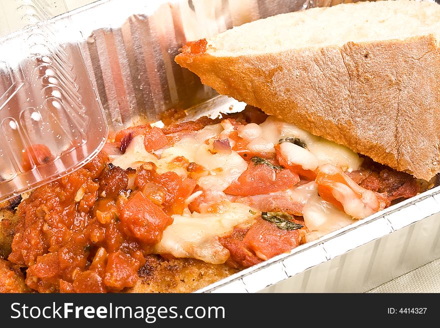 Carry out meal chicken parmesan with a slice of bread in the carry out container. Carry out meal chicken parmesan with a slice of bread in the carry out container