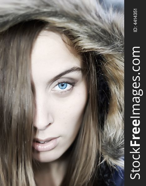 Portrait of a beautiful blue eyed young woman with a hood. Portrait of a beautiful blue eyed young woman with a hood