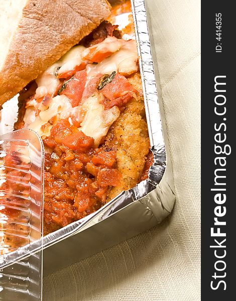 Carry out meal chicken parmesan with a slice of bread in the carry out container. Carry out meal chicken parmesan with a slice of bread in the carry out container