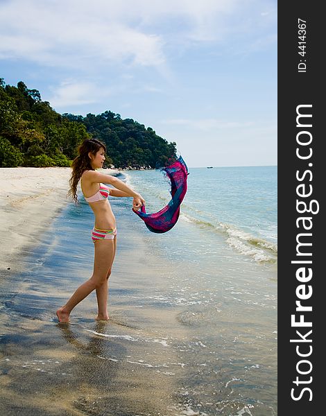 Young woman having fun at the beach