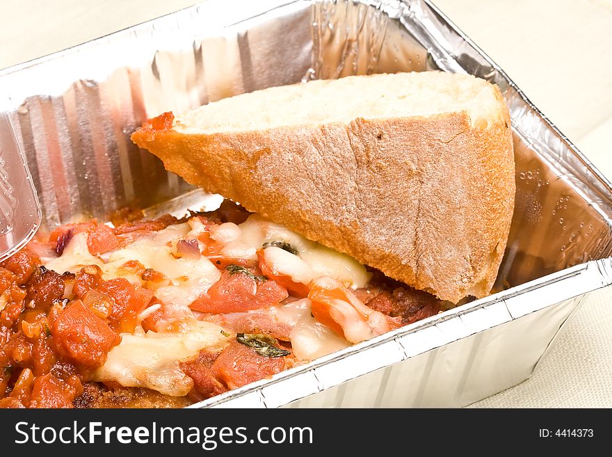 Carry out meal chicken parmesan with a slice of bread in the carry out container. Carry out meal chicken parmesan with a slice of bread in the carry out container