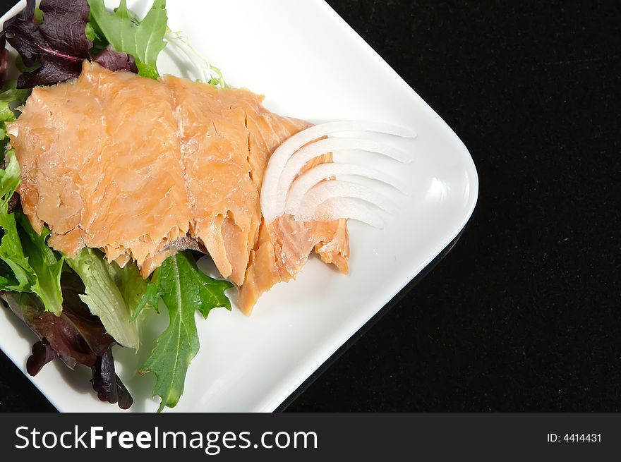 Alaskan smoked sockeye salmon starter on a bed of lettuce