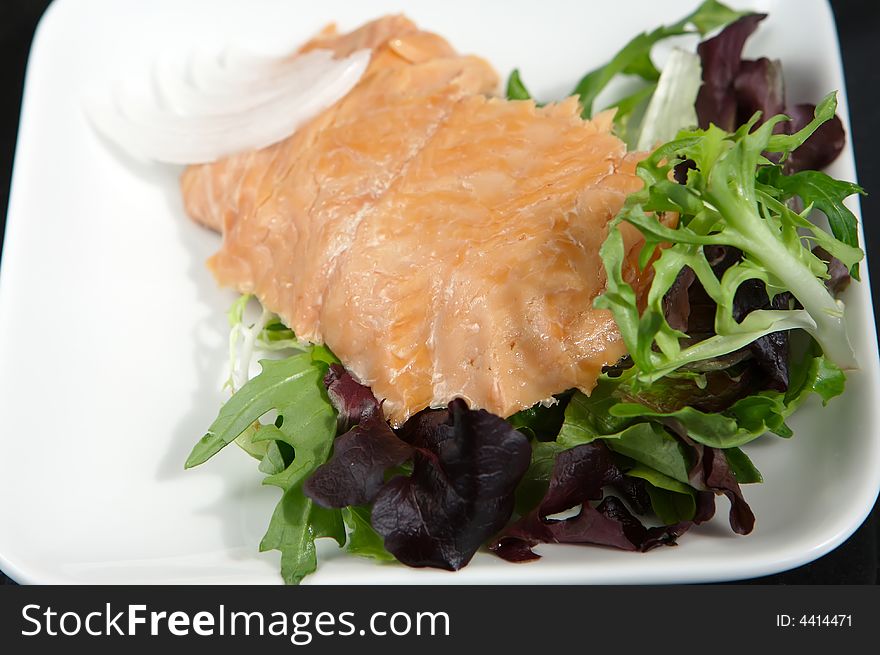 Alaskan smoked sockeye salmon starter on a bed of lettuce