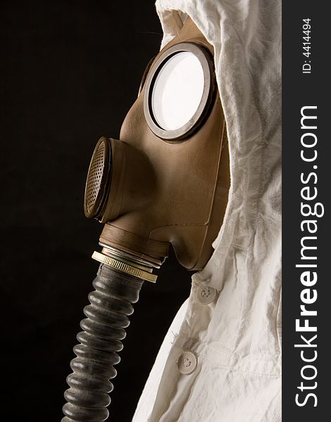 Person in gas mask on dark background