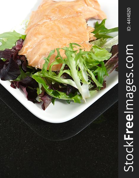 Alaskan smoked sockeye salmon starter on a bed of lettuce