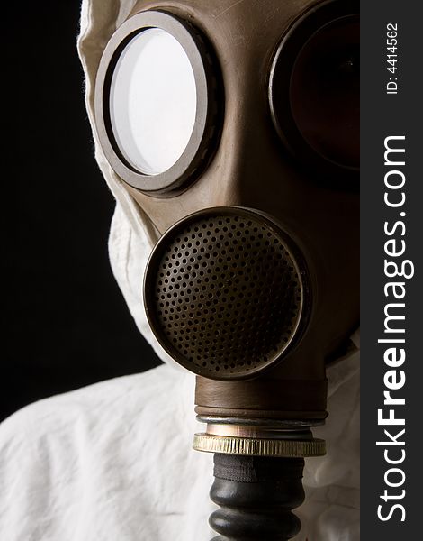 Person in gas mask on dark background