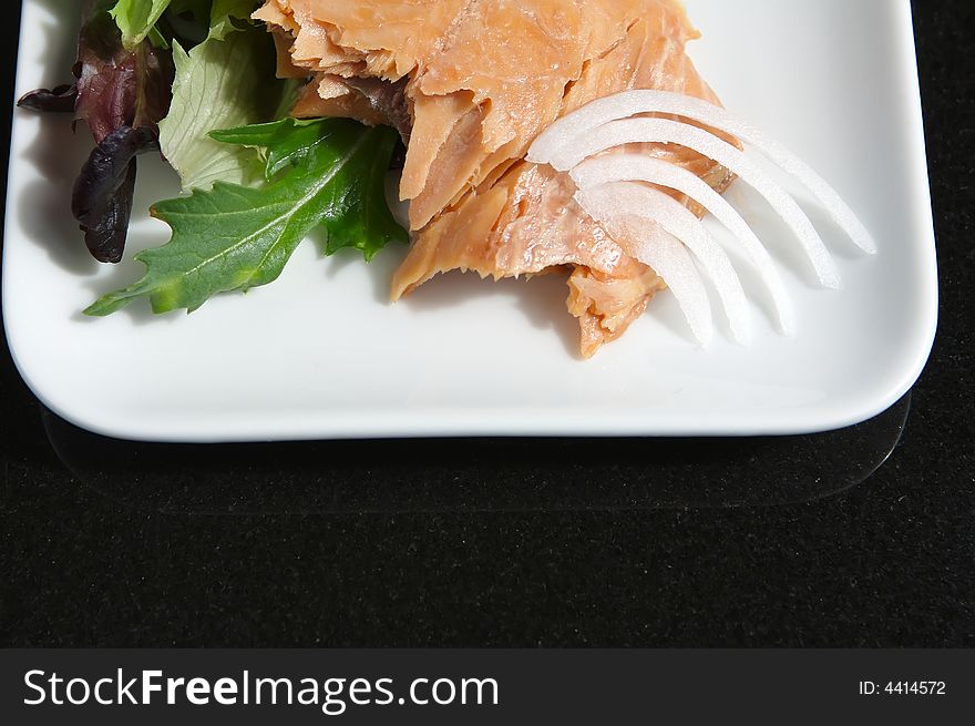 Alaskan smoked sockeye salmon starter on a bed of lettuce